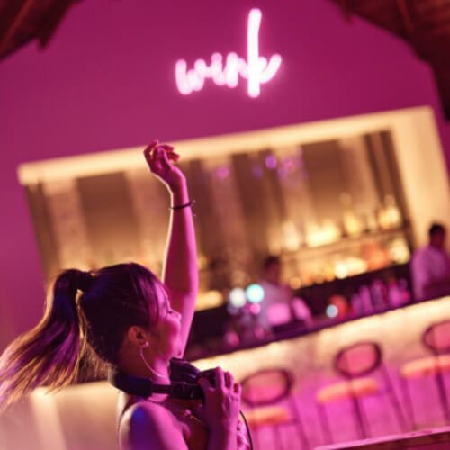 A woman DJ-ing at the bar