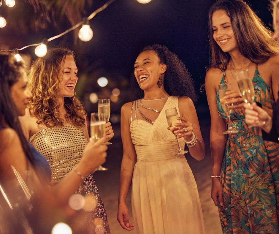 A group of women with champagne flutes, laughing together