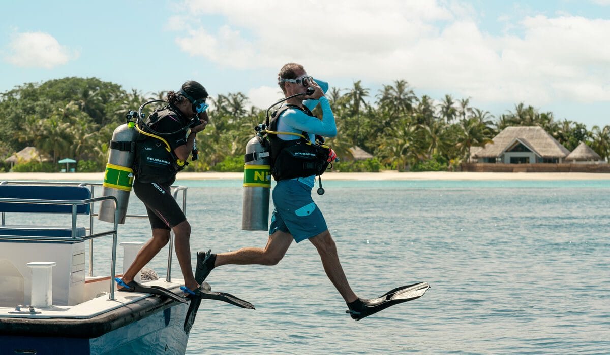 Diver jumping into the water from a boat